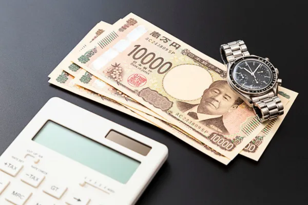 電卓とお金と時計の画像