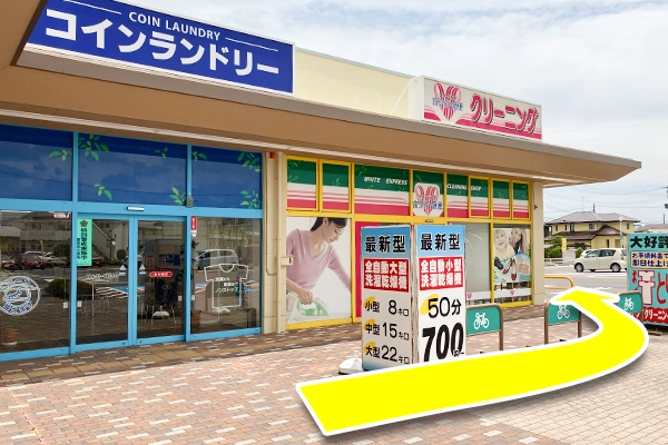 進んでいくと、左手にコインランドリーとクリーニング屋が見えます。このまま建物に沿って進んでください。