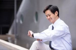 時計を見ながら笑顔の男性